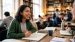 © Nina - Happy young mixed race female student studying with friends in a university library, collaborative learning and academic success concept