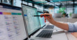 © Andrey Popov - HR Manager Reviews Payroll Software On Laptop