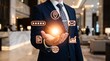 © KaziMuhibbur - A professional businessman holds glowing digital icons in a modern office lobby environment.