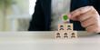 © Parradee - Workplace safety culture and employee protection. A green shield icon above wooden blocks with worker icons. Workplace safety, employee protection, risk prevention, compliance, and safety leadership.