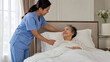 © จิรัชยา เพ็ชรทิพย์ - Caregiver assisting elderly woman resting in bed