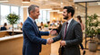 © Logo - Confident businessmen shaking hands in light office setting after successful deal meeting.