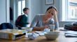 © Ashir - Weary parent pause at breakfast table during busy school morning rush at home kitchen