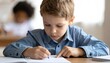 © Agung - Focused young student diligently writing in a notebook during a classroom lesson, learning and education concept