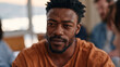 © forenna - Vulnerability and courage shown through a young South African man speaking aloud in his first public speech therapy group session, small circle of adults listening, community