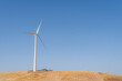 © ADDICTIVE STOCK - Wind turbine on a golden field under clear skies