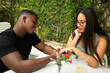 © ADDICTIVE STOCK - Multicultural couple sharing a tender moment outdoors
