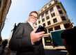 © Boris Jovanovic/Stocksy - Senior entrepreneur checks his phone outdoors