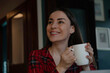 © My Ocean studio - Happy woman enjoying a hot drink at home