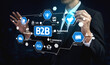 © InfiniteFlow - A businessman engages with digital technology tools to manage B2B strategies, showcasing icons that represent various aspects of e-commerce and business agreements. Tessel