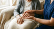 © Valfiyy - Nurse holding elderly woman's hands, caregiving and compassion, senior home care concept