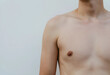© Pixel-Shot - Young mans bare chest and shoulder, health and wellness, body care and Dermatology, isolated on a light background