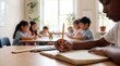 © Jian - A student hand writes in a classroom notebook beside pencils and a ruler, focusing on back-to-school learning effort