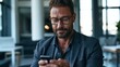 © ladart - Business Executive Using Smartphone in Modern Corporate Workplace
