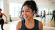 © Hiiro-Studio - Cheerful Japanese woman with a sweaty face smiling during a group exercise workout in a studio