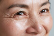 © JoeyMarut - Extreme close up portrait of middle aged Japanese woman smiling with visible cheek wrinkle and natural skin texture, bright eyes and expressive crow feet conveying warmth and vitality