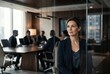 © Olena Apetroaiei - Business meeting in a modern office with a woman sitting near glass walls and observing colleagues