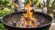 © jaana - Glowing embers and crackling flames rising from ignited charcoal briquettes within a metal grill basin during outdoor cooking preparation. Intense heat radiating from smoldering fuel source with