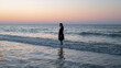 © bephoto - 静かな波の海辺で水しぶきを上げる日本人女性の写真