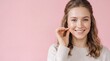 © MSTKHADIZA - Young woman with wavy hair in a beige sweater touching her cheek, smiling against a pink ad social media download thambnail poster web template event festival 2026 2027 2028