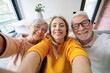© Daniel - Happy multigenerational family smiling for a selfie, bonding deeply and showing connection during a moment of love and happiness together in their bright home