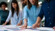 © Bussakon - A group of professionals collaboratively reviewing color swatches on a table during a design meeting