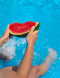 © yanadjan - Children with watermelon near the pool. Selective focus.