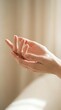 © Yuliia - Woman's hands cupped together in open gesture against soft beige background, conveying care, giving, receiving, hope and support for wellness, charity and community concepts.