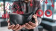 © Bi - Hands hold empty wallet with red downward charts symbolizing financial loss