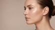 © Alva - Side profile of a young woman with glowing skin and natural makeup on a neutral background. Ideal for beauty and skincare advertising.