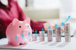 © JK_kyoto - Savings growth concept. Piggy bank and rising coin stacks with percentage arrows represent compound interest, wealth, investment, profit, planning, future
