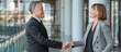 © BESTIMAGE - Two diverse senior business professionals shaking hands for greeting after successful deal discussion in modern office environment representing partnership agreement and corporate collaboration.