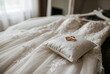 © Meow Creations - Gold wedding rings resting on pillow over lace bridal gown
