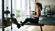 © Icha Arleza - Woman training back muscles on seated row machine in modern gym