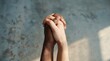 © Ana - Close up of two people with different skin tones holding hands together in unity.