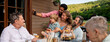 © Halfpoint - Multigenerational family having bbq party and taking selfie.