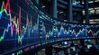 © Dara - Several large LED screens display complex stock market charts with fluctuating red, green, and blue lines. The screens are arranged in a curved row, reflecting the activity of a trading floor.