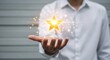© Camilla - Person in white shirt holding a glowing gold star, representing achievement