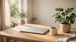 © Kamal - Minimalist home office desk with laptop, monstera plant and ceramic mug in warm morning light