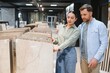 © Serhii - Couple choosing ceramic tiles in hardware store