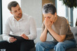 © Serhii - Psychologist counseling a crying woman during therapy session