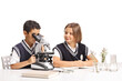 © Ljupco Smokovski - Schoolchildren doing a science experiment with a microscope