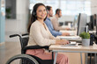 ©  Arise Leo - Young adult woman with disability working in call center, wearing headset and using computer in team office. Customer support and inclusive workplace concept for service business marketing