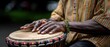 © pvl0707 - Musician plays djembe drum with skilled hands and colorful attire during outdoor performance in natural light