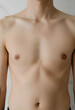 © Pixel-Shot - Bare chest and torso of a young adult man, health and wellness, body care and dermatology, close up studio shot