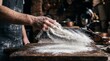 © adi - Baker Hand Dusting White Flour on Dark Wooden Board in Motion