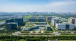 © Liew - Aerial view of a sprawling modern technology park with sleek architecture and lush green spaces under a clear blue sky.