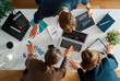 © Konstantin Yuganov - Teamwork Collaboration at Business Meeting with Financial Charts And Analytics