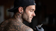 © I-D-U - Tattoo Gun Being Used by Focused Professional Artist