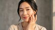 © Ctra - Radiant Young Asian Woman With Natural Glowing Skin Touching Her Face for Skincare Routine and Beauty Concept